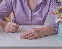 Senior citizen coloring in an adult coloring book