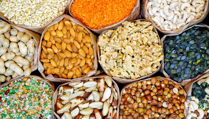 An assortment of nuts and seeds in bags from a farmer’s market.