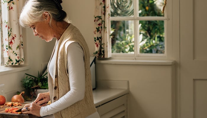 Senior female cooking.