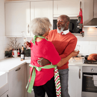 Adult with Alzheimer’s dancing in the kitchen.