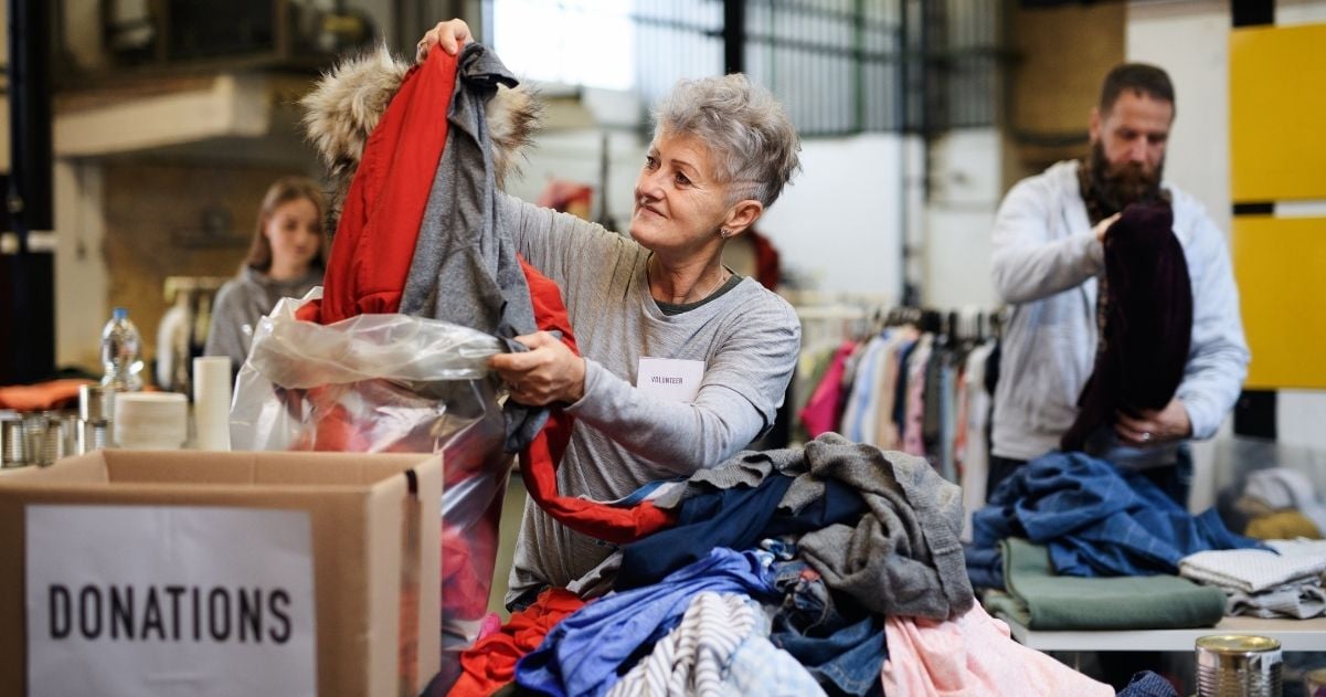 Woman sorting through donated clothing.