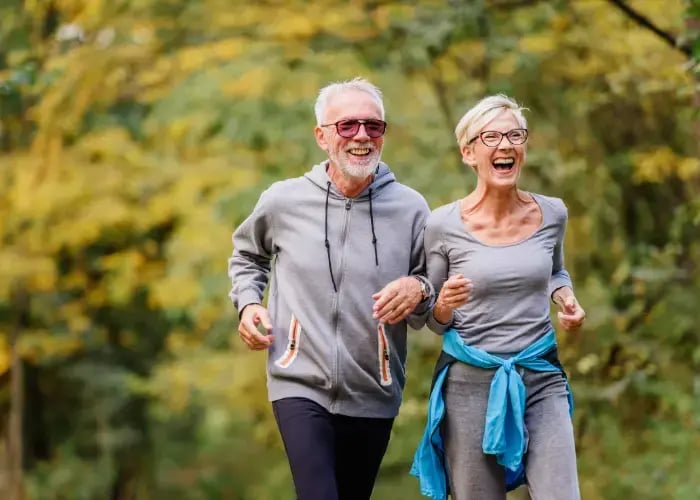 exercise-benefitsCheerful active senior couple jogging in the park. Exercise together to stop aging.