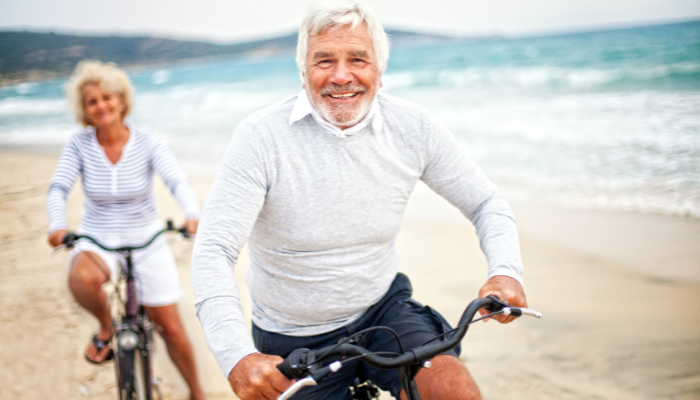 Mature adults riding bicycles  to maintain their healthy lifestyle. 