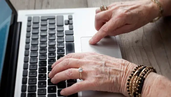 Senior woman creating a Facebook account