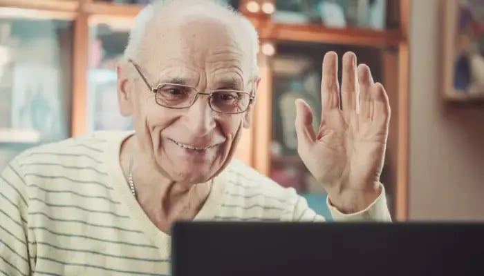 Senior man on a zoom call with his family