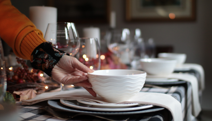 person setting a table for the holidays