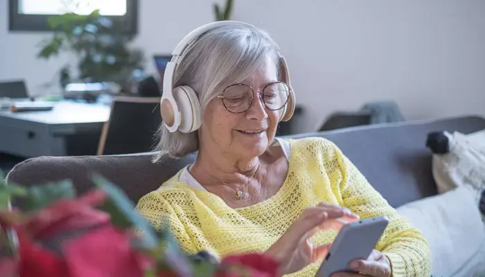 Mature woman listening to a podcast on her phone