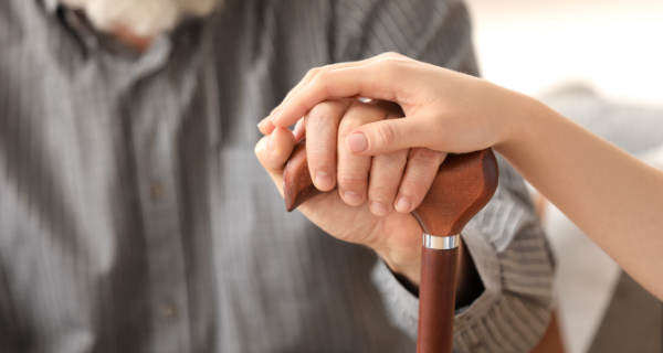 Caregiver comforts her loved one with Alzheimer’s disease.