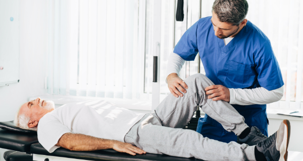Senior man having his joints looked over by a therapist.