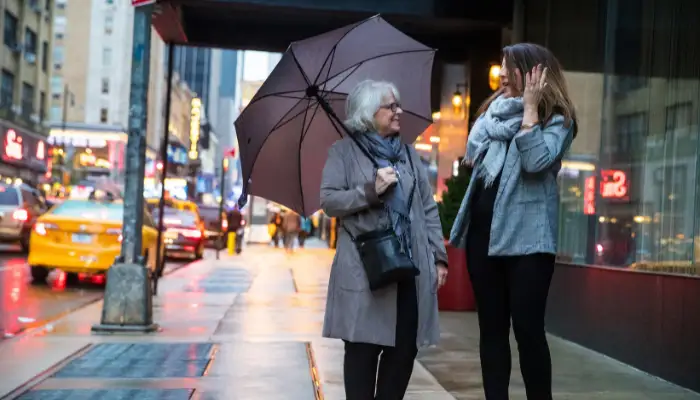 Adult daughter and senior mother explore New York City together during the spring